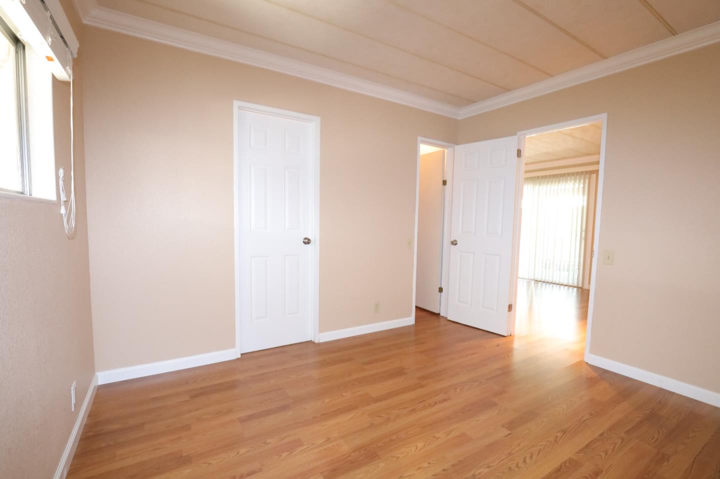 61 Quail Hollow Drive, Unit 61 San Jose, CA 95128 - Photo 21 of 36 an empty room with wooden floor and windows