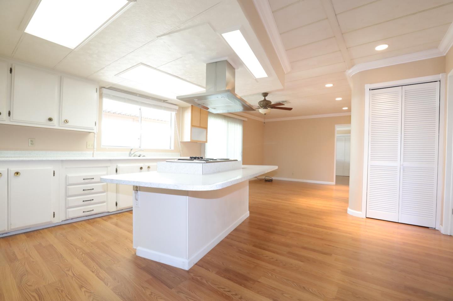 61 Quail Hollow Drive, Unit 61 San Jose, CA 95128 - Photo 31 of 36 a large kitchen with cabinets wooden floor and stainless steel appliances