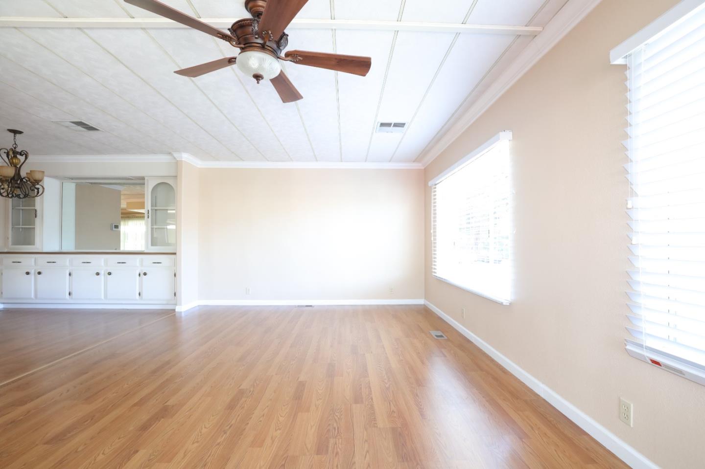 61 Quail Hollow Drive, Unit 61 San Jose, CA 95128 - Photo 4 of 36 an empty room with wooden floor fan and windows