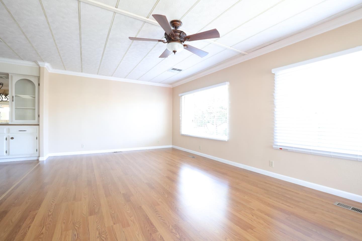 61 Quail Hollow Drive, Unit 61 San Jose, CA 95128 - Photo 5 of 36 an empty room with wooden floor fan and windows
