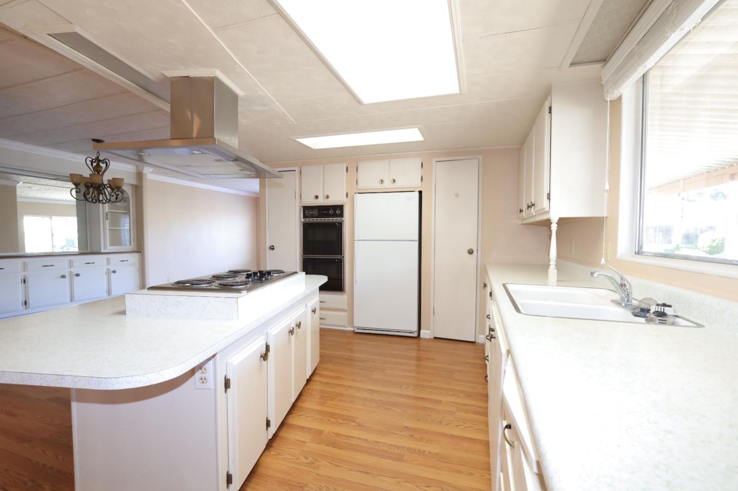 61 Quail Hollow Drive, Unit 61 San Jose, CA 95128 - Photo 10 of 36 a kitchen with a sink stove and refrigerator