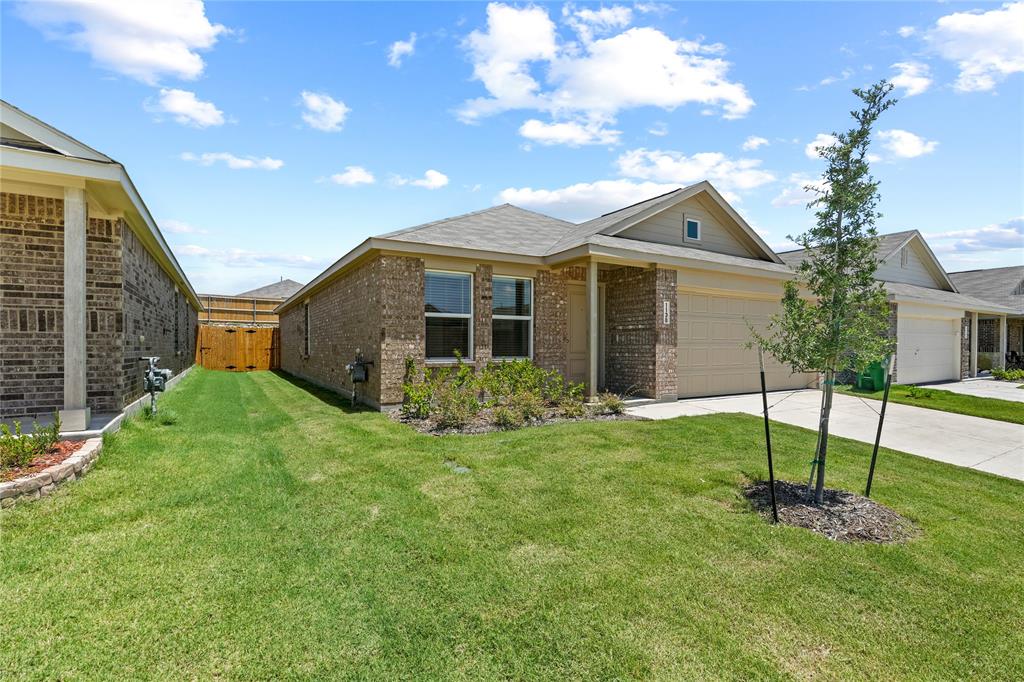 1138 Barbary Flds Street Forney, TX 75126 - Photo 2 of 25 Single-story residence featuring a brick and siding facade, an attached garage, and a covered entry porch
