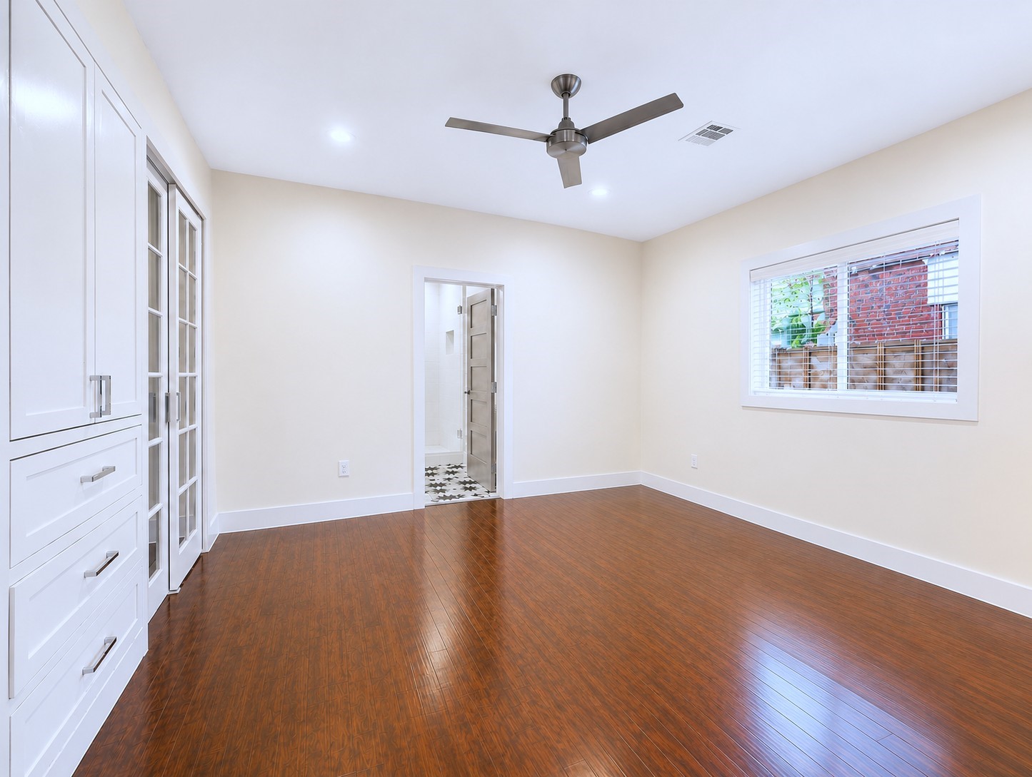 2302 Ruth Street Houston, TX 77004 - Photo 6 of 18 The 1st floor primary bedroom with ceiling fan & recessed lighting.