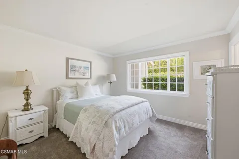 a spacious bedroom with a bed and a window