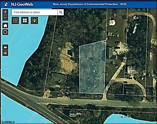 an aerial view of a residential houses with yard