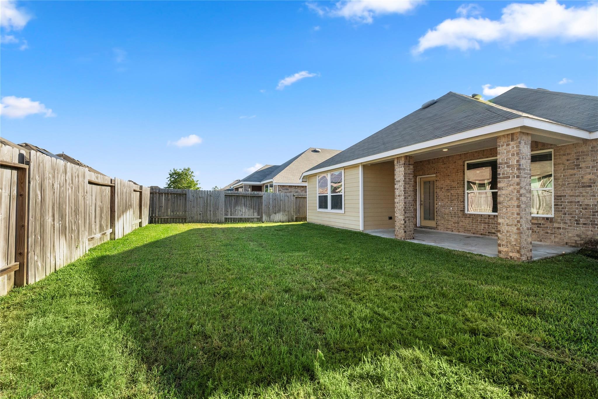 29507 Whitebrush Trace Drive Spring, TX 77386 - Photo 2 of 32 Fenced backyard with green lawn and rear exterior view.