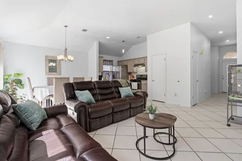 a living room with furniture and a chandelier