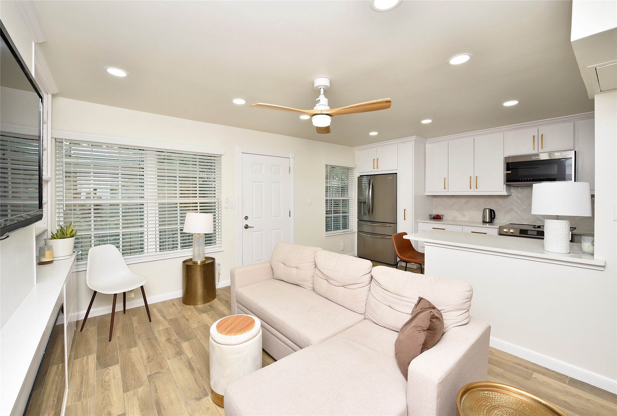 3224 Timmons Lane, Unit 112 Houston, TX 77027 - Photo 22 of 30 a living room with stainless steel appliances furniture and a kitchen view