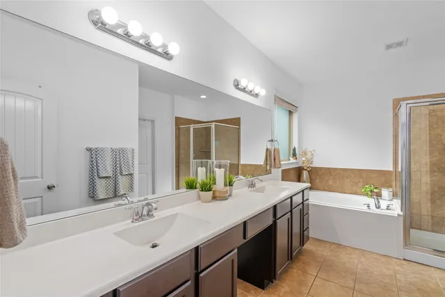 a bathroom with a tub sink and mirror