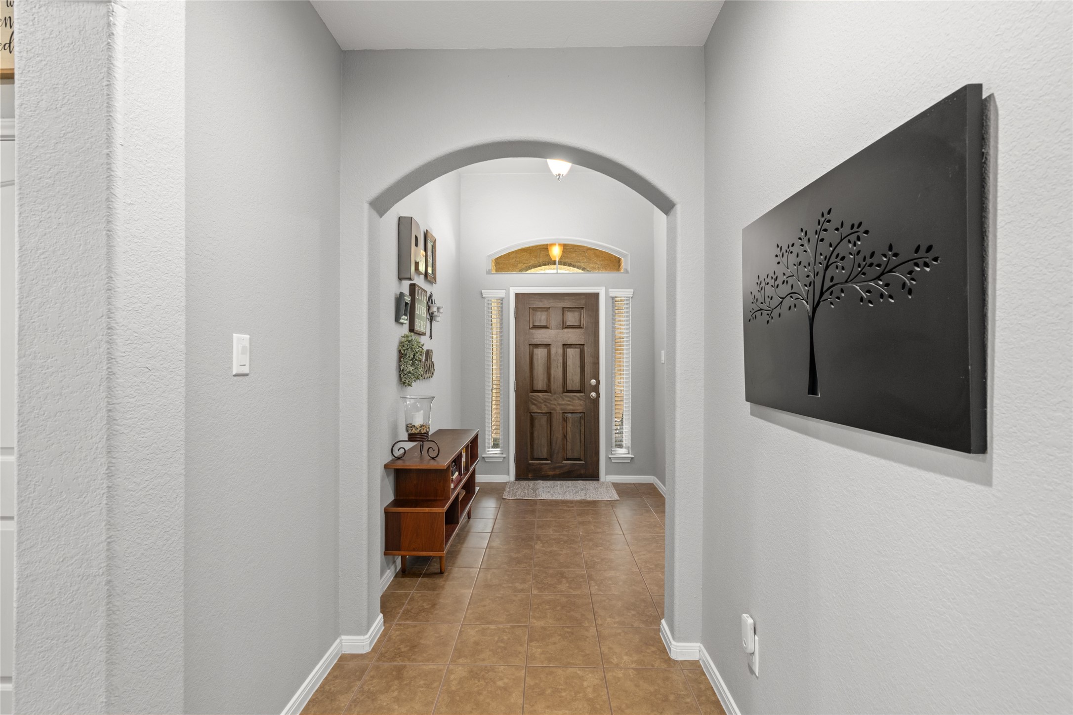 1071 Cedar Lake Court Conroe, TX 77384 - Photo 28 of 43 a view of a hallway with wooden floor and a living room