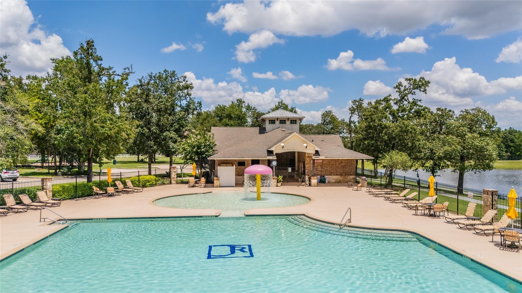 1071 Cedar Lake Court Conroe, TX 77384 - Photo 36 of 43 a swimming pool with outdoor seating and yard