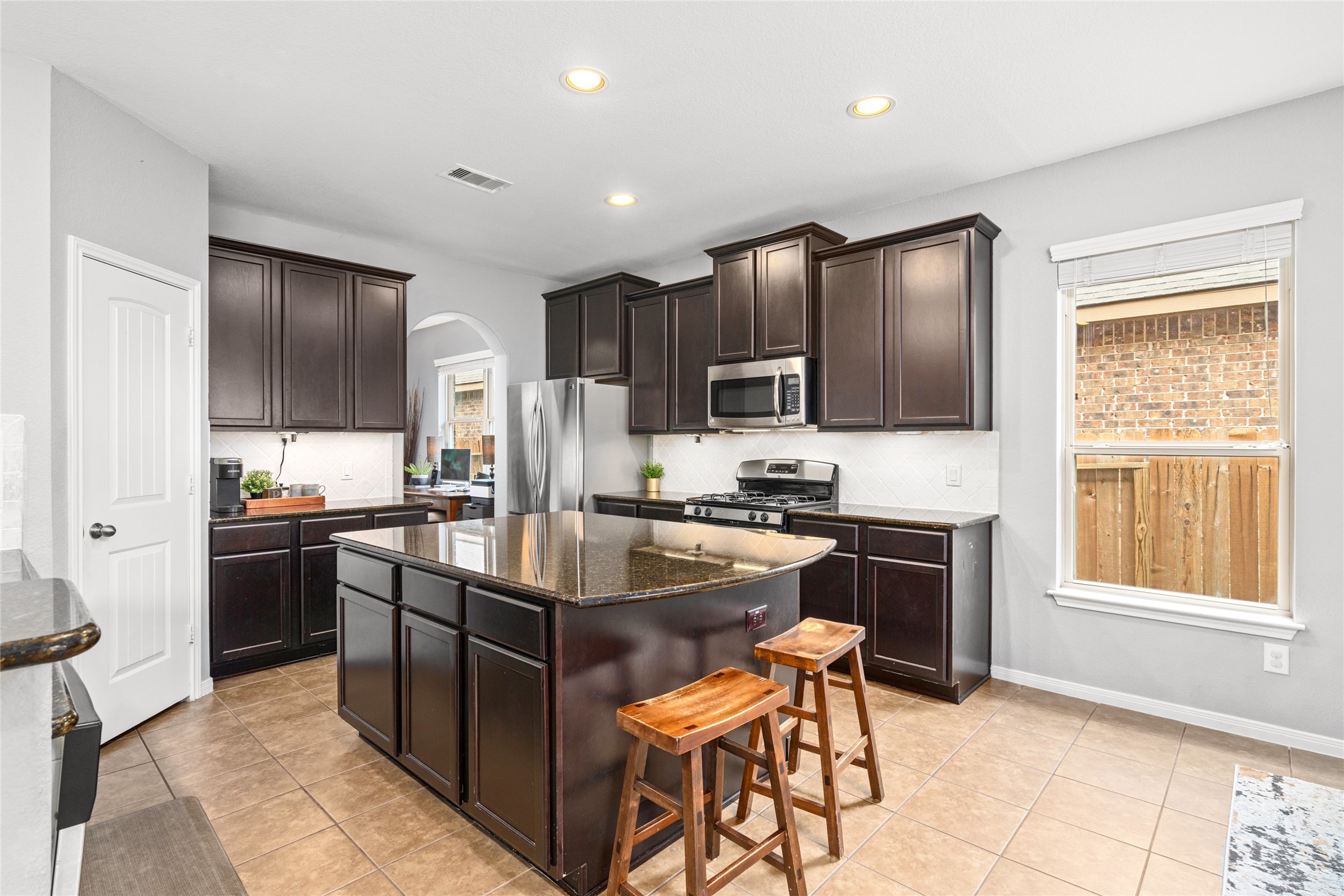 1071 Cedar Lake Court Conroe, TX 77384 - Photo 4 of 43 a kitchen with stainless steel appliances granite countertop a stove refrigerator sink and cabinets