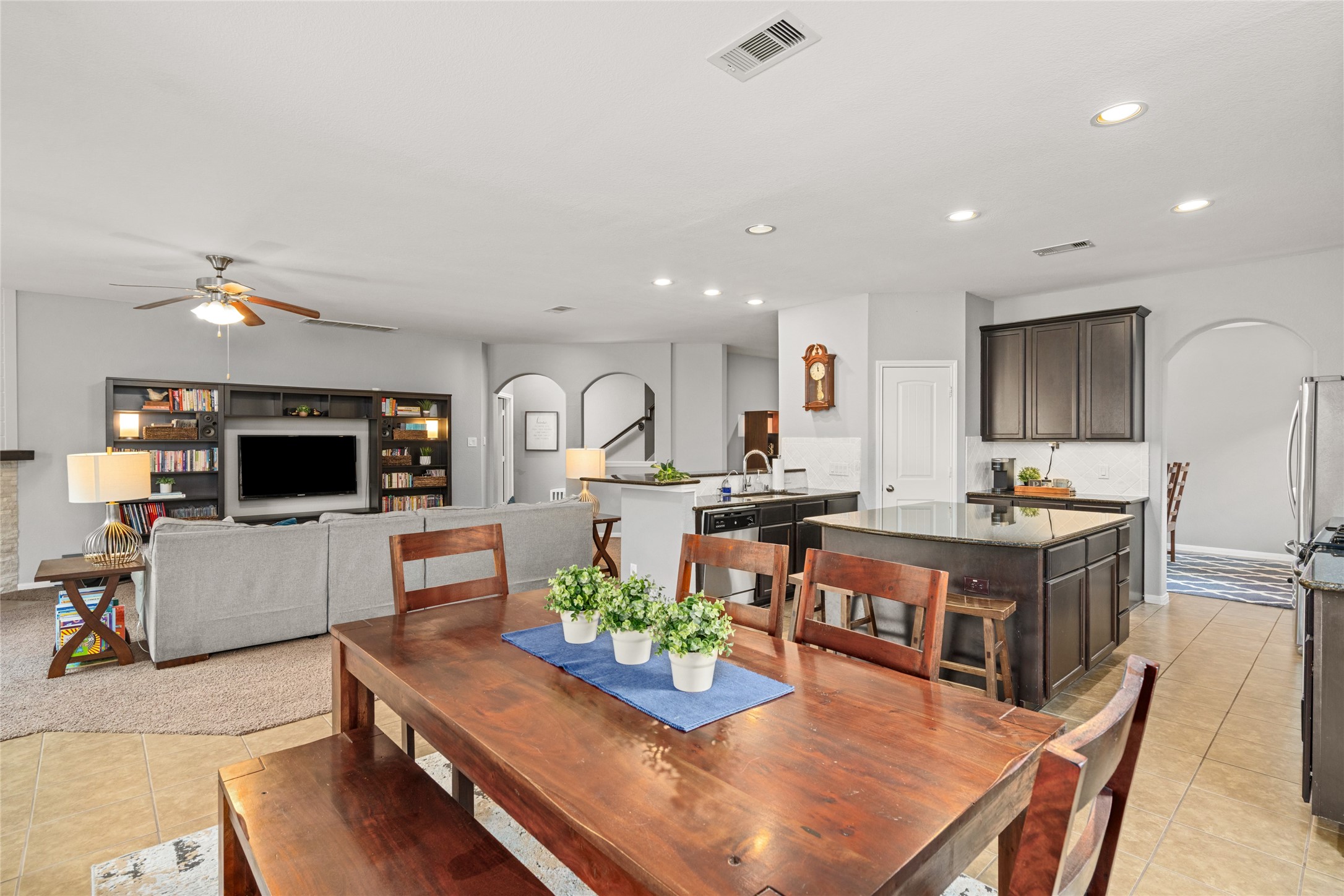 1071 Cedar Lake Court Conroe, TX 77384 - Photo 5 of 43 a living room with furniture a flat screen tv and kitchen view