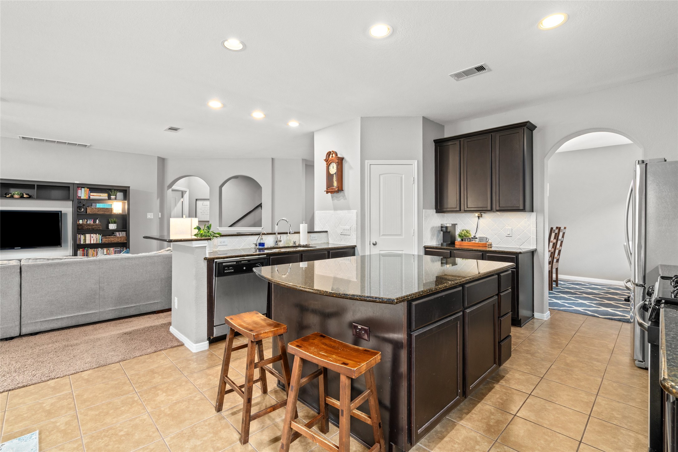 1071 Cedar Lake Court Conroe, TX 77384 - Photo 7 of 43 a kitchen with stainless steel appliances granite countertop a sink and a refrigerator