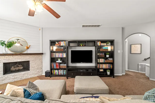 a living room with furniture and a fireplace
