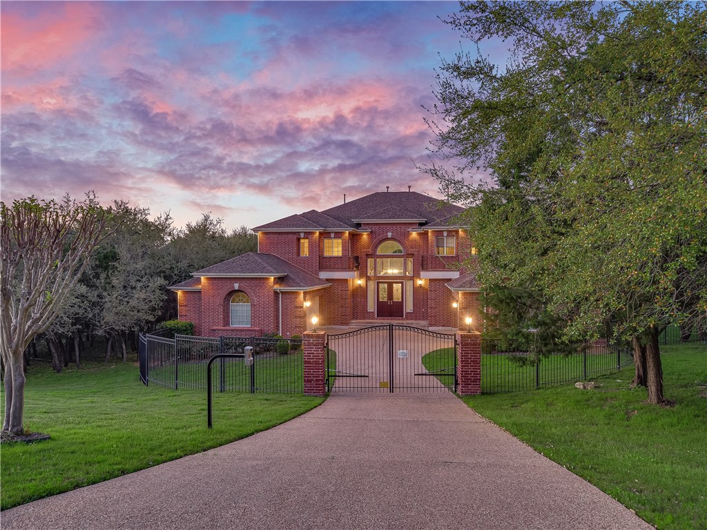 a front view of a house with a garden and a yard