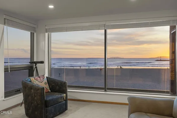 a bed room with a bed and large windows