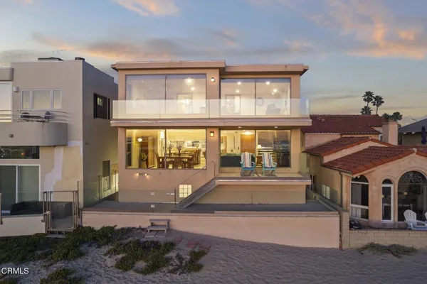 a view of a building with a floor to ceiling window and a living room