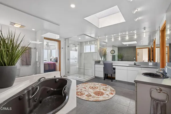 a bathroom with a shower sink and mirror