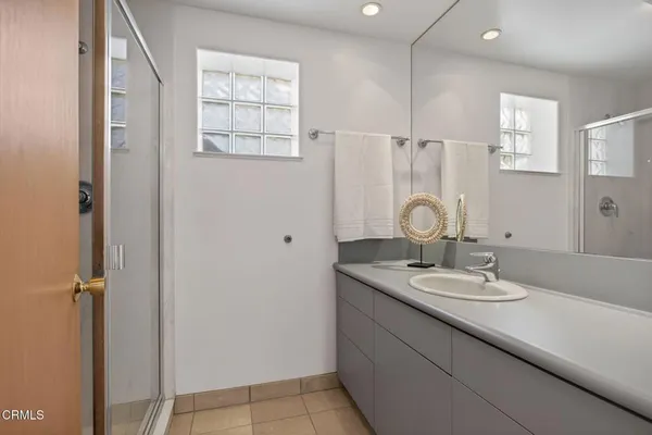 a bedroom with a bed a couch and dresser