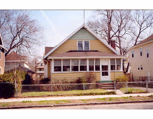 65 Mooreland Street Springfield, MA 01104 - Photo 1 of 1 a view of a white house with large windows next to a road