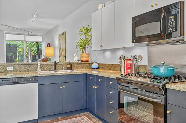 a living room with furniture flowerpot and wooden floor