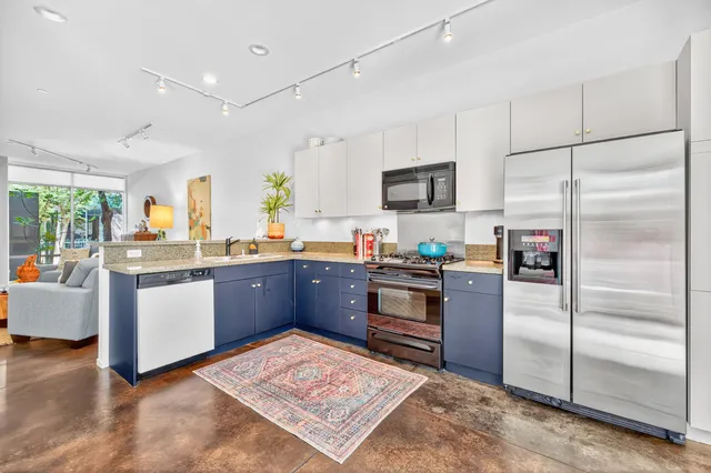 a kitchen with granite countertop stainless steel appliances and wooden cabinets