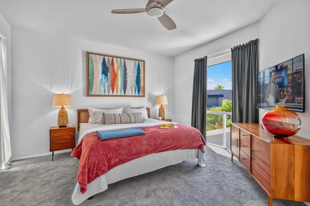 a bedroom with a bed and painting on the wall