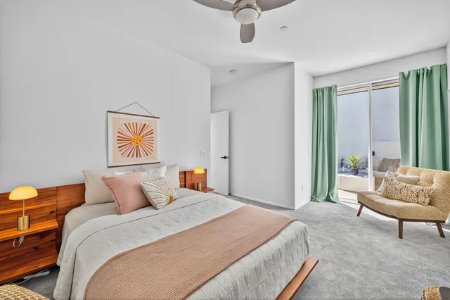 a bedroom with a bed and a couch