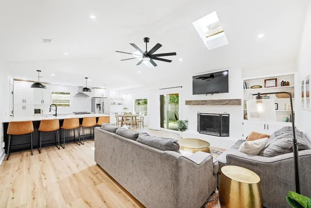 a living room with furniture a fireplace and a flat screen tv