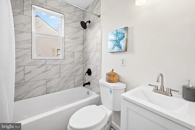 a bathroom with a sink toilet and bathtub