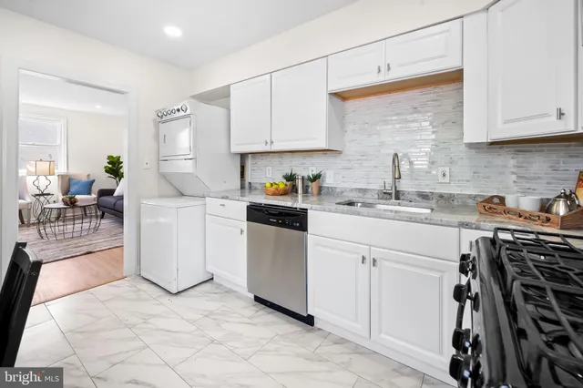 a kitchen with white cabinets and white appliances