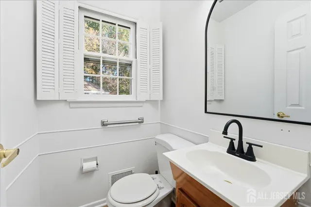 a bathroom with a sink vanity and toilet