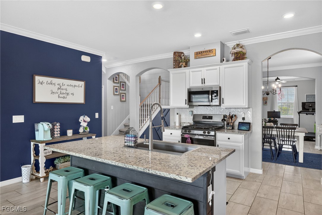 43325 Waymark Place Punta Gorda, FL 33982 - Photo 13 of 49 a kitchen with kitchen island granite countertop a sink counter and chairs