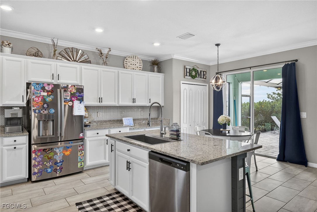 43325 Waymark Place Punta Gorda, FL 33982 - Photo 15 of 49 a kitchen with stainless steel appliances granite countertop a sink stove and refrigerator