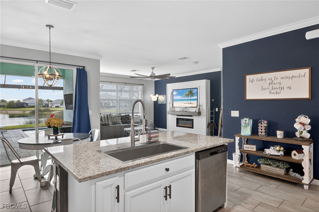 43325 Waymark Place Punta Gorda, FL 33982 - Photo 16 of 49 a kitchen with a sink a counter and chairs