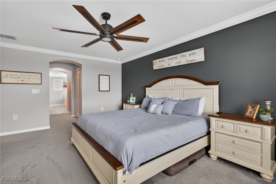 43325 Waymark Place Punta Gorda, FL 33982 - Photo 22 of 49 a bedroom with a bed and a chandelier