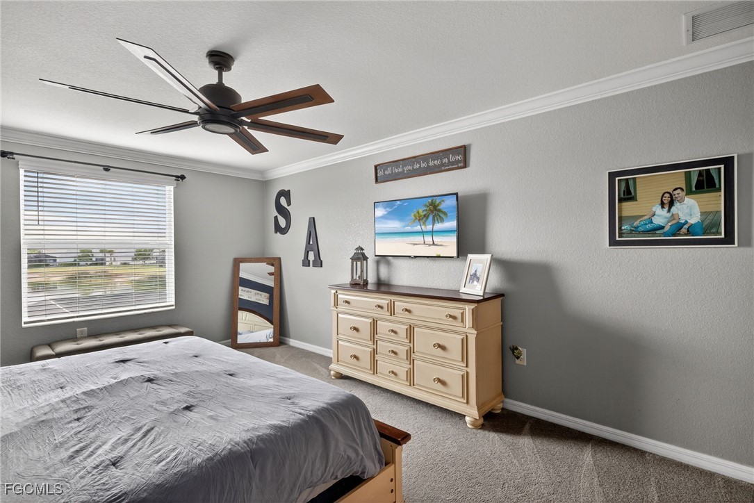 43325 Waymark Place Punta Gorda, FL 33982 - Photo 23 of 49 a bedroom with a bed and a dresser