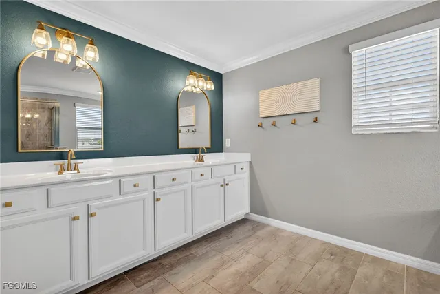 a spacious bathroom with 2 sink and a mirror
