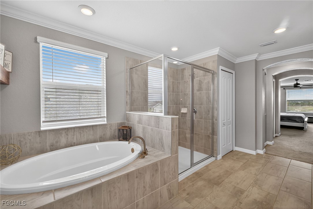 43325 Waymark Place Punta Gorda, FL 33982 - Photo 25 of 49 a spacious bathroom with a bathtub and a shower