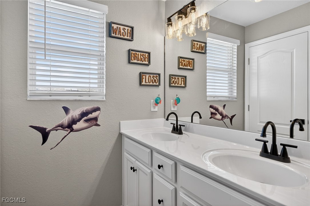 43325 Waymark Place Punta Gorda, FL 33982 - Photo 30 of 49 a bathroom with a sink and a mirror