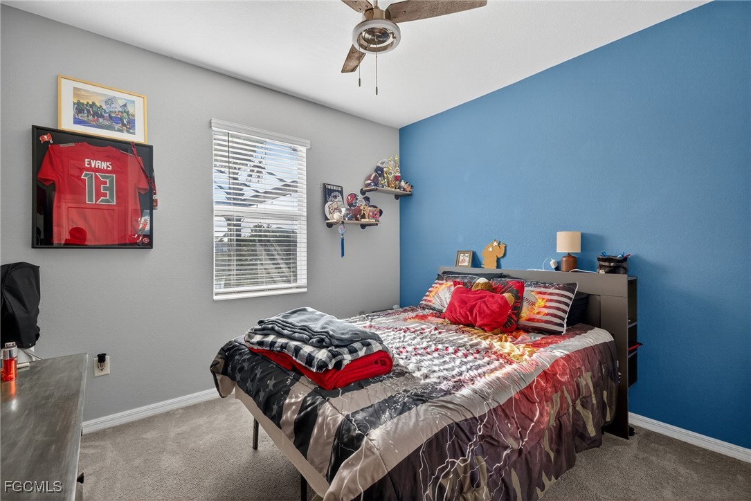 43325 Waymark Place Punta Gorda, FL 33982 - Photo 33 of 49 a bedroom with a bed and a chandelier