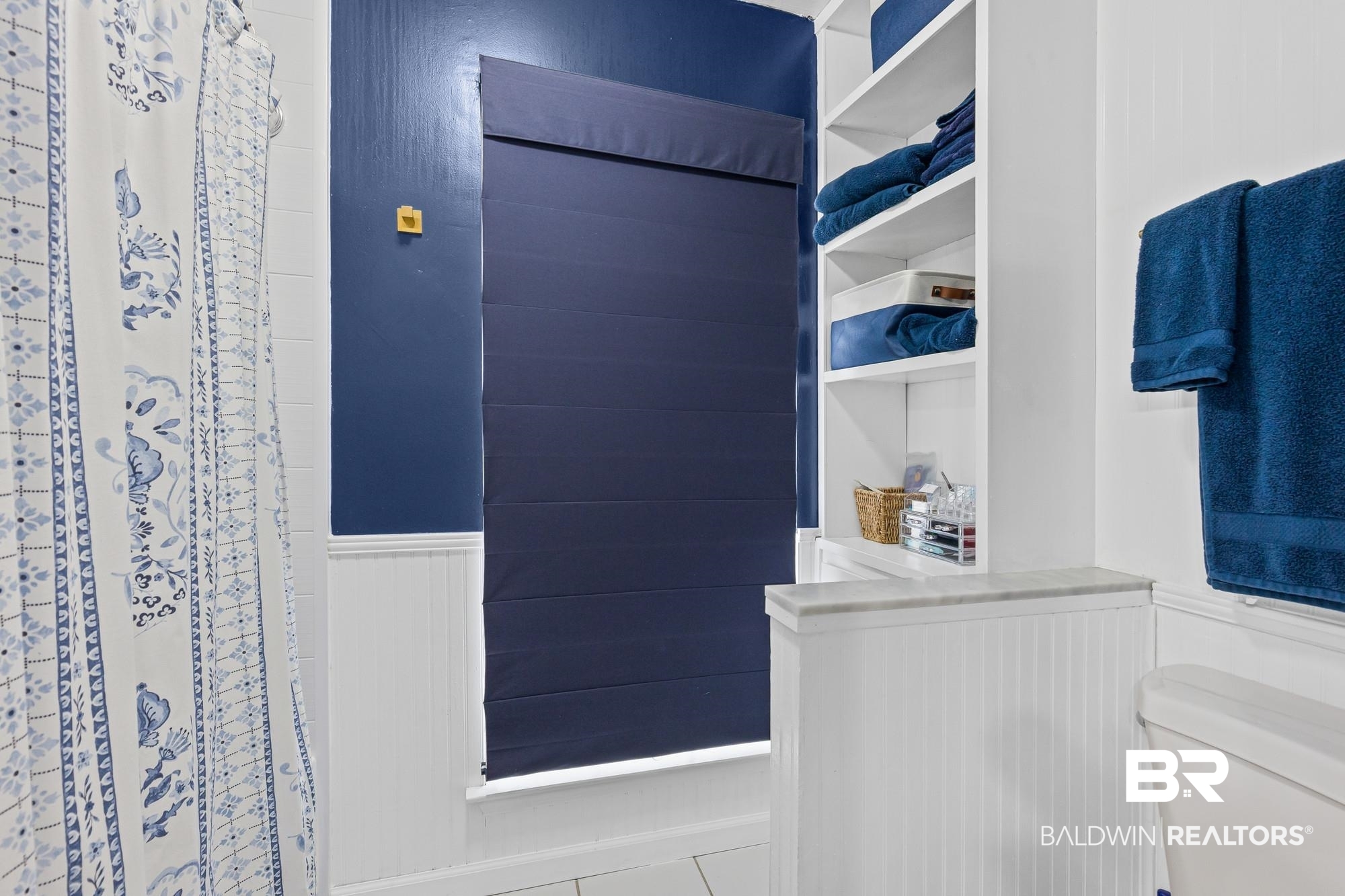 6609 Blakeley Court Mobile, AL 36695 - Photo 15 of 28 Bathroom featuring a shower with curtain, a wainscoted wall, and tile patterned floors
