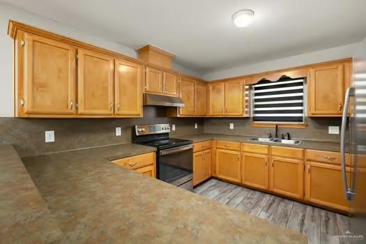 1403 Tierra Rica Avenue Alamo, TX 78516 - Photo 6 of 13 a kitchen with stainless steel appliances granite countertop a stove a sink and a microwave
