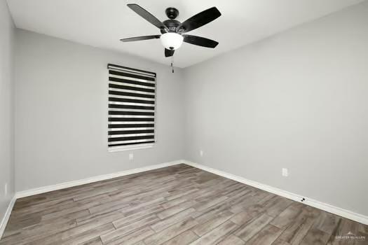 1403 Tierra Rica Avenue Alamo, TX 78516 - Photo 10 of 13 wooden floor in an empty room with a window