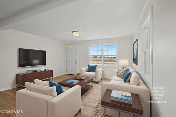 a living room with furniture and a flat screen tv