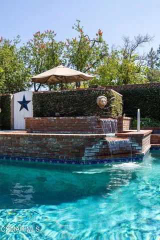 a view of yard with swimming pool and green space