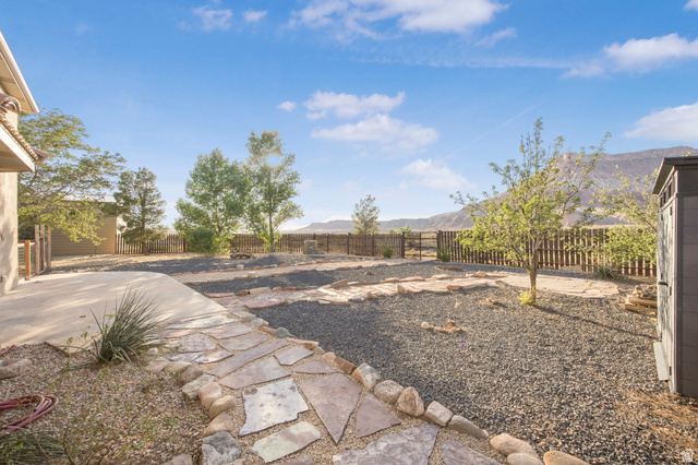 1440 West 100 South Virgin, UT 84779 - Photo 36 of 45 Expansive outdoor area featuring a concrete patio, flagstone pathway, and gravel landscaping