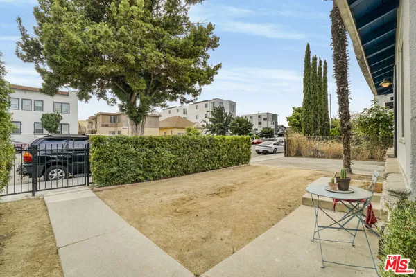 a view of a backyard with sitting area