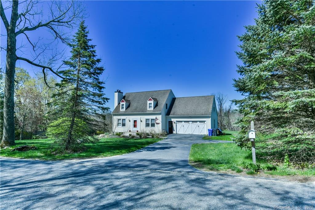 249 Quasset Road Pomfret, CT 06259 - Photo 1 of 1 a front view of a house with a yard and a garage